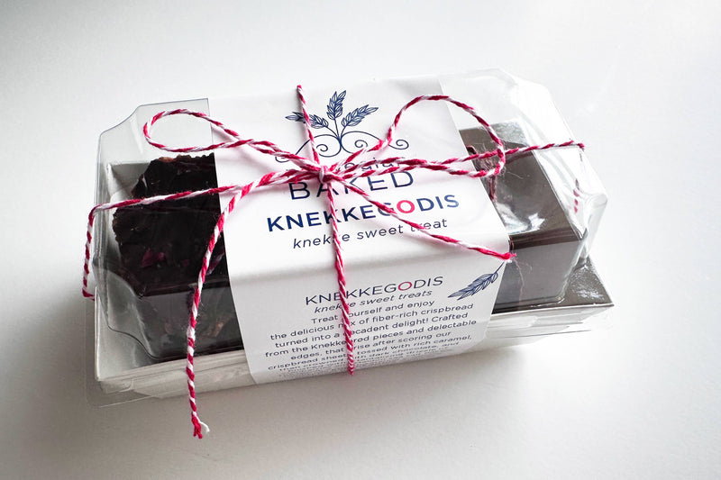 Norwegian Baked - KnekkeGodis, a sweet Nordic cookie toffee bark in a neatly tied white package with red and white string, perfect as a gift.