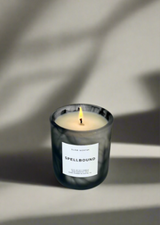 Slow North - Spellbound candle in marbled vessel, lit to reveal tangerine, ginger, and cinnamon scent. Hand-poured, limited edition for Halloween, 10 fl. oz., Austin, TX.