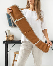 Woman holding MagicLinen - Double oven mitt (1 pcs): Natural Gingham, designed for heat protection, made from excess linen as part of a zero-waste initiative.