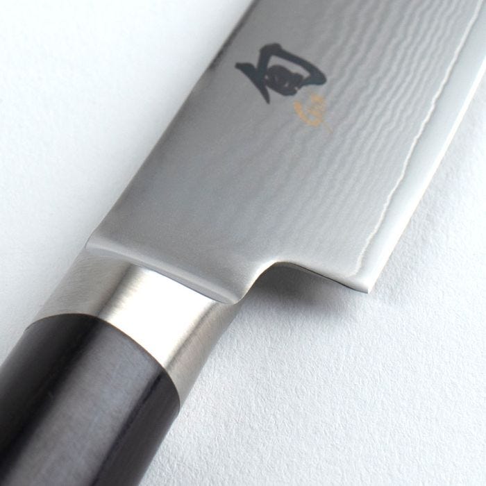 Shun | Classic Utility Ebony, 6 inches knife features a polished Damascus blade and D-shaped ebony-finished handle, showcasing craftsmanship ideal for precise culinary tasks.