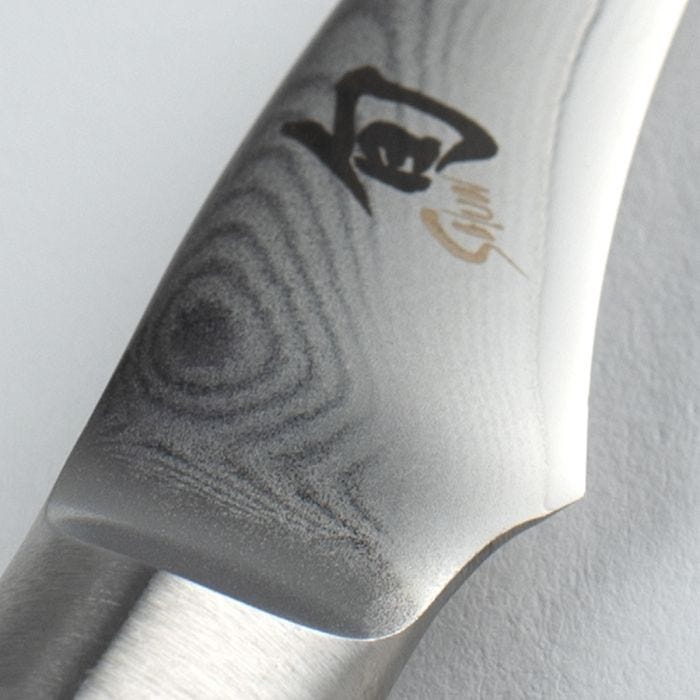 Close-up of Shun Classic Bird's Beak Paring knife, 2.5 inches, showcasing the Damascus steel pattern and bolster, ideal for decorative and precise culinary cuts.