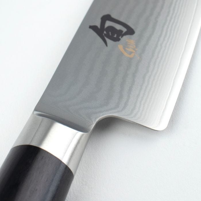 Shun Classic Chef's Ebony, 6 inches knife features a Damascus-style blade with kanji maker's mark, showcasing its lightweight, maneuverable design ideal for precise slicing and dicing.