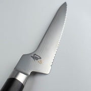 Shun Classic Offset Bread Knife, 8.25 inches, with serrated Damascus blade and dark wood handle, designed for precise slicing without knuckle interference.