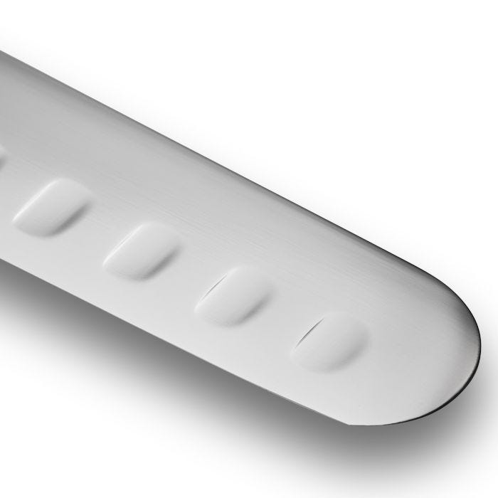 Close-up of the Shun Classic Hollow Ground Brisket Knife blade, featuring hollow-edge dimples for easy food release; ideal for precise meat slicing.