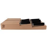 Shun | In-Drawer Knife Trays, 15 Slot: Beechwood tray with horizontal slots, holding black-handled kitchen knives, designed for compact, drawer storage of Shun cutlery.