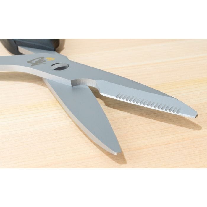 Shun Kitchen Shears, 9 inches, featuring smooth and serrated blades, lay open on wood; versatile, Japanese steel, separable for cleaning.