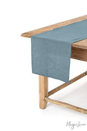 MagicLinen - Linen table runner displayed on a wooden table, showcasing its soft texture and decorative function, suitable for enhancing dining aesthetics.