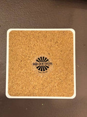 Drinks on Me - COASTER What The Fuck: A cork coaster with a playful logo, ideal for adding humor to any home bar or gift collection.