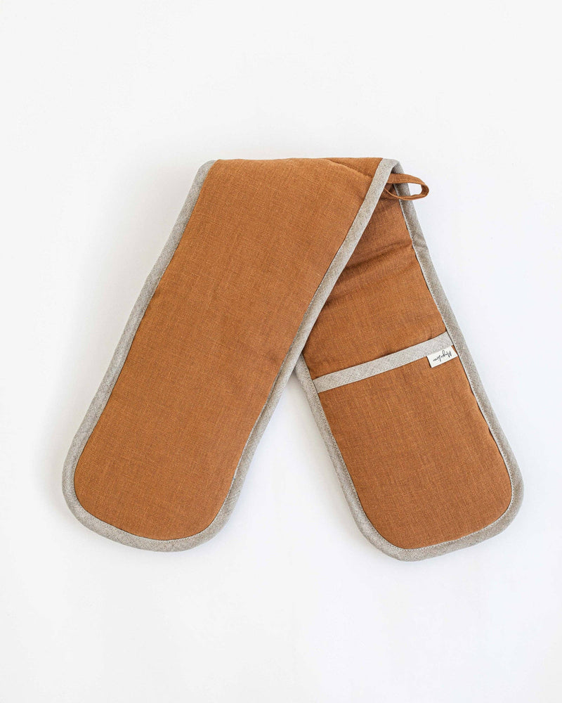 MagicLinen double oven mitts in natural linen, featuring a brown fabric with gray trim and a white tag, designed for heat protection in the kitchen.