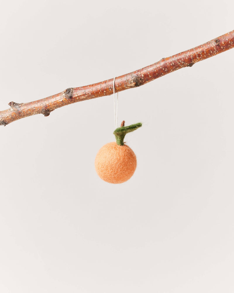 Farmhouse Pottery - Felted Fruit Ornament: Clementine hanging from a branch, made of hand-felted orange wool with a green leaf and brown stem.