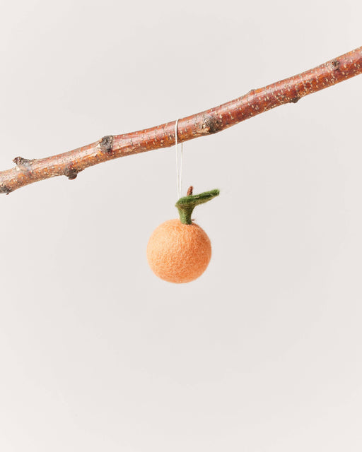 Farmhouse Pottery - Felted Fruit Ornament: Clementine hanging from a branch, made of hand-felted orange wool with a green leaf and brown stem.