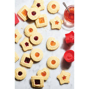 Assorted cookies made with HIC - Harold Import Co. - King Arthur Thumbprint Cookie Cutters, featuring embossed edges and jam centers, alongside a bowl of jam and silicone molds.