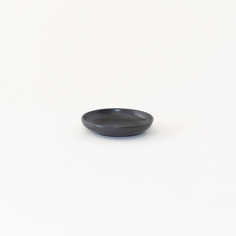 Sarah Kersten - Olive Dish: Basin Collection: Classic White, a small, round black dish ideal for serving olives, part of a versatile kitchenware collection.