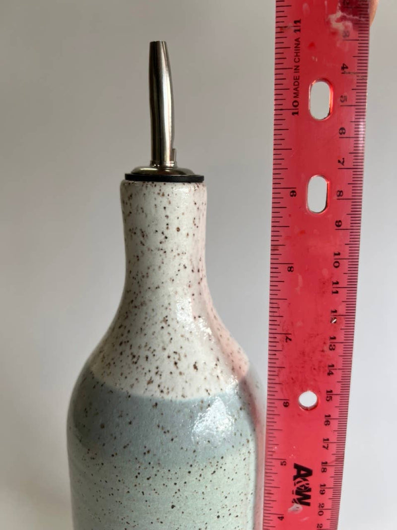 RachaelPots - Oil Cruet Large: Nude/White with a metal pour spout next to a ruler, showcasing its size and intricate design.