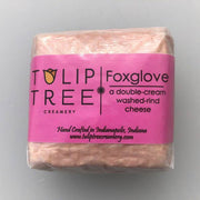 Tulip Tree Creamery - Foxglove cheese package with a pink label, showcasing its award-winning double cream washed rind and soft, runny texture. 8 oz square.