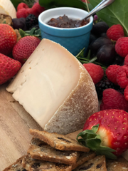 Tulip Tree Creamery - Hops: 5 Oz. Wedge, a double cream cheese, accompanied by strawberries and crackers, perfect for pairing with wine or beer.