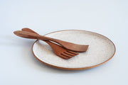 RachaelPots - Serving Platter: Sage, speckled off-white ceramic with brown rim, features crossed wooden utensils. Hand-thrown, microwave and dishwasher safe.