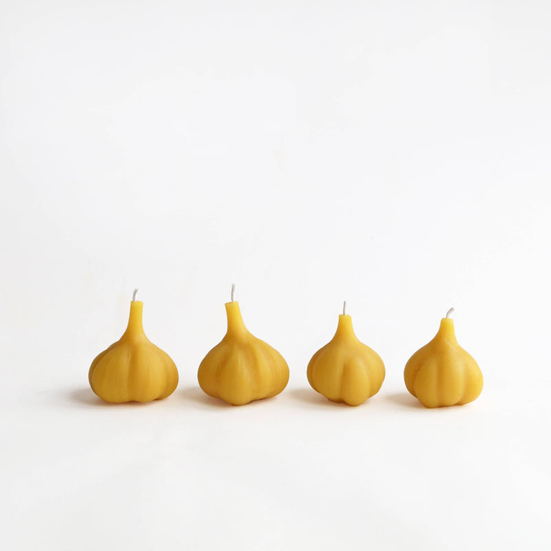 Artifaqt - Garlic Beeswax Candle, molded from garlic with sweet honey aroma, displayed on a white surface.