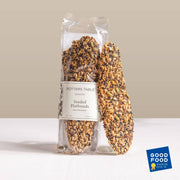 Potters Table - Seeded Olive Oil Flatbreads, artisanal crackers with mixed seeds, clear-packaged, showcasing a Good Food Awards Winner '23 badge. Ideal for cheese boards and elegant gatherings.