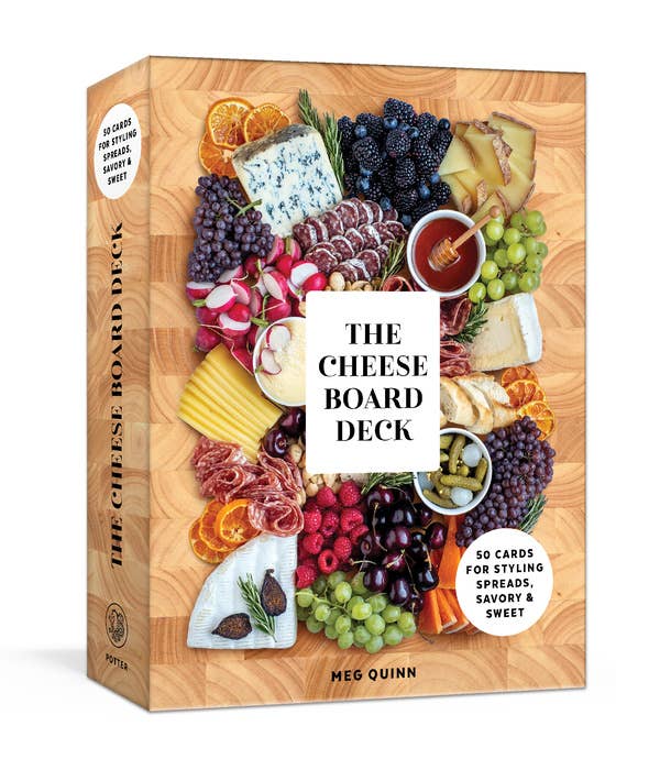 The Cheese Board Deck by Meg Quinn: Box cover showing an abundant cheese board with meats, fruits, nuts, and honey. Contains 50 cards for creative board styling.