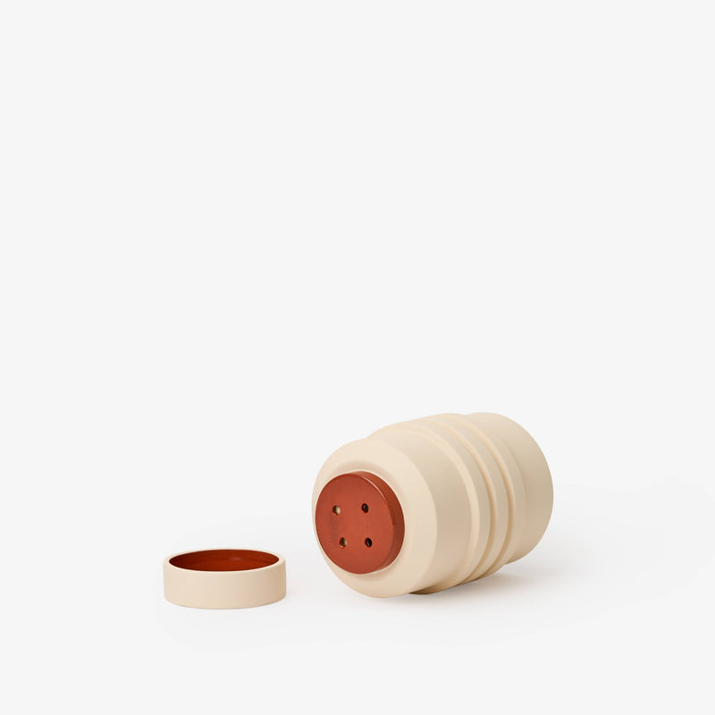 Areaware - Strata Plant Vessel: Green, a ceramic planter featuring layered shapes that conceal the saucer, inspired by sculptural jewelry design.