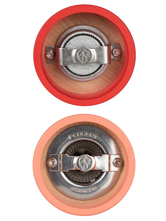 Peugeot | Tahiti Duo Salt + Pepper Mills, Fire, featuring two wooden mills with Peugeot's lion-stamped metal plates, showcasing durable grinding mechanisms in red and peach exteriors.