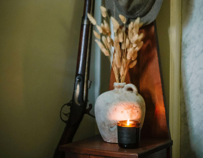 Lodestone | Luxury Soy Candles - Winterberry & Cypress in an elegant bottle, highlighting its artisanal label crafted with vintage letterpress and gold-flecked inks.