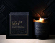 Luxury Lodestone Winterberry & Cypress soy candle in a black box with gold text, showcasing an elegant flame, perfect for decorative or reuse purposes.
