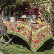 Caravan Home 71 x 71 Red & Green Tablecloth on a dining table, adorned with plates and a bowl of cherries, showcasing artisan craftsmanship.