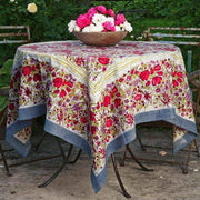 Caravan Home 59 x 86 Red & Grey Tablecloth on a table with a floral centerpiece, reflecting Southern France garden-inspired elegance, ideal for indoor or outdoor dining.