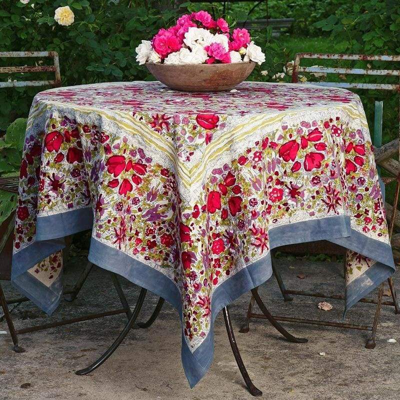 Caravan Home 59 x 86 Red & Grey Tablecloth on a table with a floral centerpiece, reflecting Southern France garden-inspired elegance, ideal for indoor or outdoor dining.