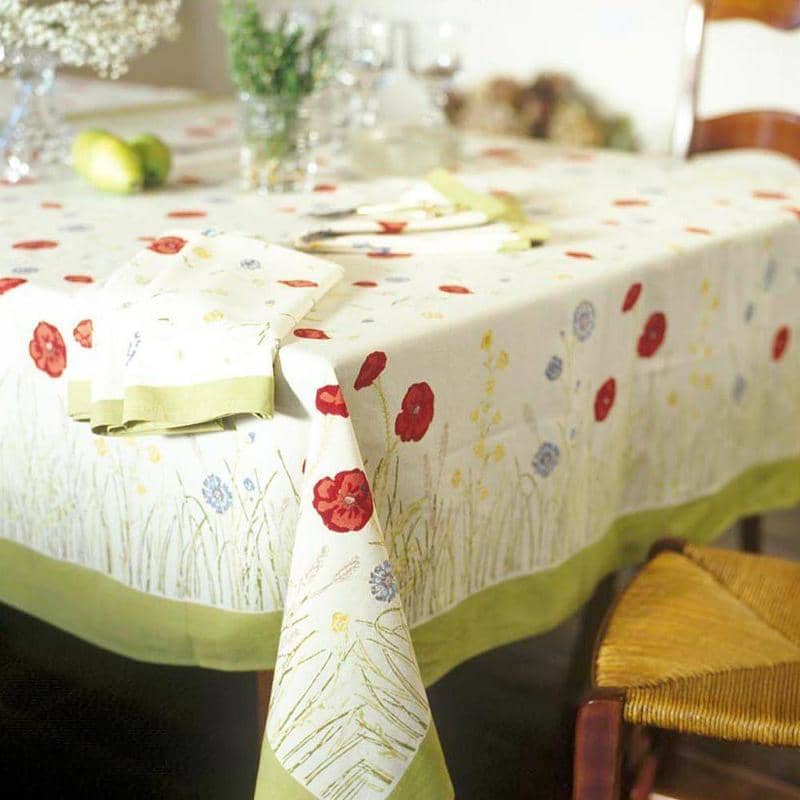Caravan Home | 71 x 71 Springfields Multi French Tablecloth on a decorated table with glasses, featuring poppies and wildflowers, handprinted for a touch of Provençal charm.