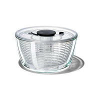 OXO Good Grips Salad Spinner with non-slip knob and base, featuring a dual-purpose spinning basket and compact storage design, ideal for efficient salad preparation.