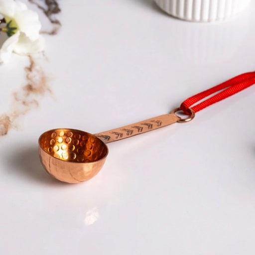 ALFIQ Handmade Copper Miniature Kitchen Utensil Ornament, Ladle with textured bowl, engraved handle, and red ribbon loop, ideal for decor or gifting.