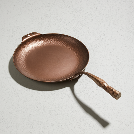 Smithey carbon steel Farmhouse Skillet with hand-forged handle and hammered sides