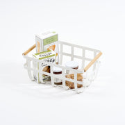 Yamazaki Home's large Steel + Wood Storage Basket holds an assortment of crackers and spreads, showcasing a stylish, organized snack presentation.