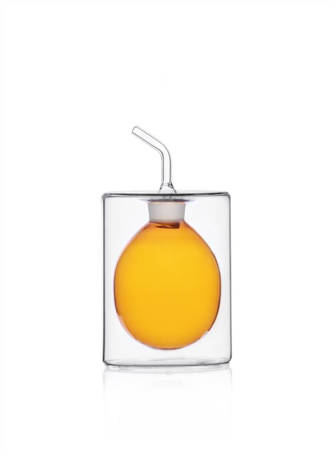 Ichendorf | Cilindro Colore Oil Bottle, Amber, 5.1 oz, features a double-walled glass with an egg-shaped inner chamber, showcasing its elegant, modern design for kitchen use.