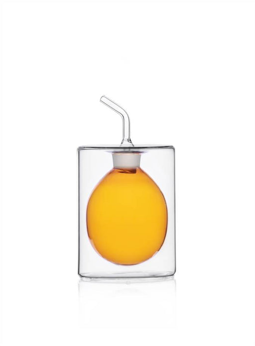 Ichendorf | Cilindro Colore Oil Bottle, Amber, 5.1 oz, features a double-walled glass with an egg-shaped inner chamber, showcasing its elegant, modern design for kitchen use.