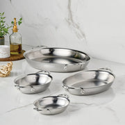 Hestan Provisions | Chef's Special Oval Clad Au Gratin pans in four sizes on a countertop, surrounded by kitchen essentials, capturing elegance and functionality.