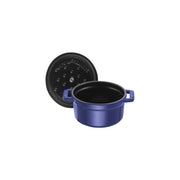 Staub | Mini Round Dutch Oven, Dark Blue, 0.25 QT., featuring a glossy blue finish with loop handles, and a self-basting matte black interior. Perfect for single-serve creations.