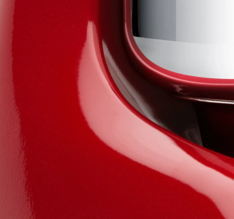 Close-up of the Ankarsrum Stand Mixer in red, featuring its rounded body and silvery visor, ideal for heavy doughs with a 7-liter bowl.