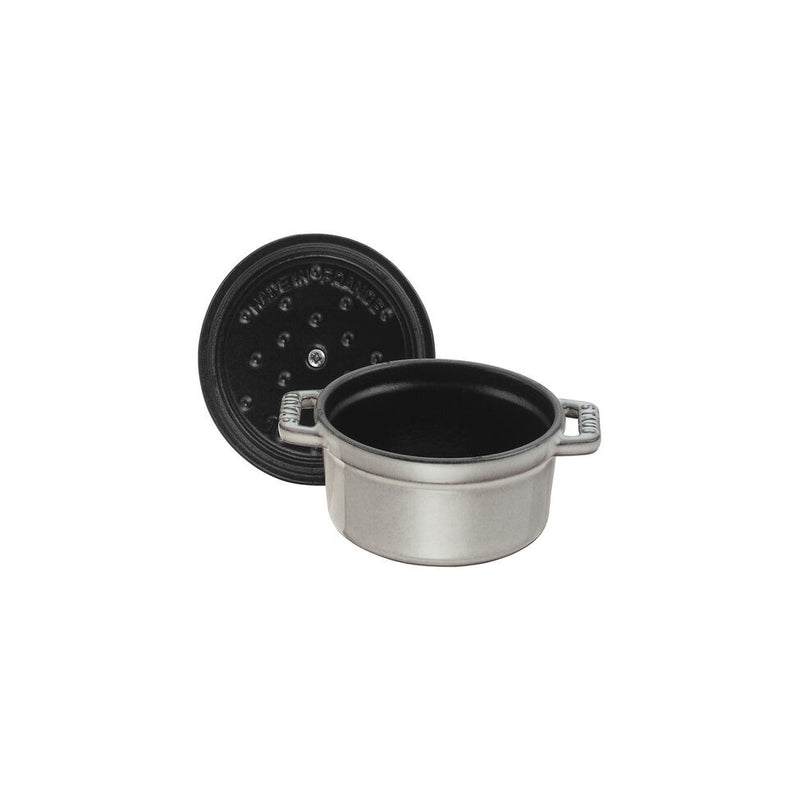 Staub | Mini Round Dutch Oven, Graphite, 0.275 QT. features a matte-gray finish with a self-basting lid, perfect for single-serve culinary creations.