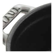 Staub Mini Round Dutch Oven in graphite, 0.275 QT, close-up showing enameled cast iron rim and handle, ideal for single-serve culinary creations.