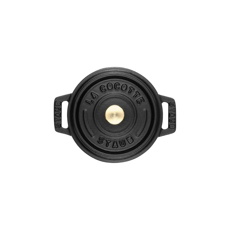 Staub | Mini Round Dutch Oven, Black, 0.275 QT, top-down view with embossed lid and side handles, embodying Staub's renowned craftsmanship for single-serve culinary creations.