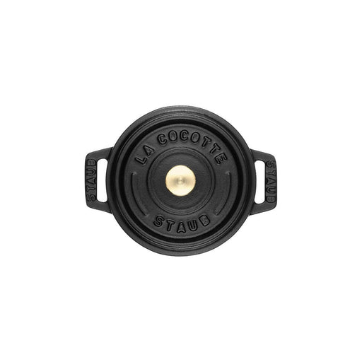 Staub | Mini Round Dutch Oven, Black, 0.275 QT, top-down view with embossed lid and side handles, embodying Staub's renowned craftsmanship for single-serve culinary creations.