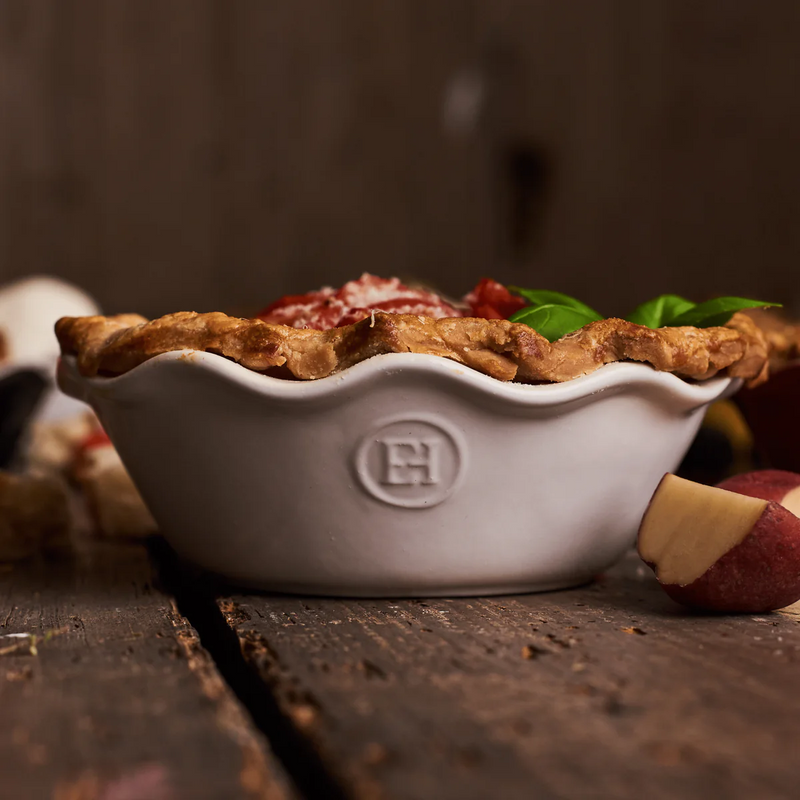 Emile Henry | Modern Classics Mini Pie Dish Set of 2, showcasing hand-crimped crust with tomato filling, cheese, and basil, highlighting even heat distribution for perfect baking.