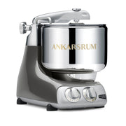 Ankarsrum Assistent Original stand mixer with stainless-steel bowl on grey base, featuring dual dials, ideal for heavy dough mixing, available at Athens Cooks.