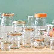 Le Parfait Super Jars - 750ml, showcasing clear glass jars with various lids, perfect for preserving and storage, embodying French durability and elegance.