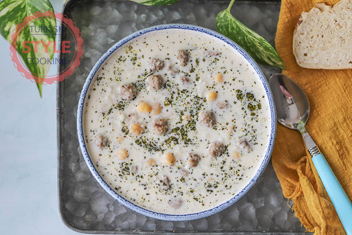 Turkish yogurt soup with meatballs and chickpeas in a blue-rimmed bowl, part of Soups for the Season with Fatma Gurel cooking class, December 12, 2025.