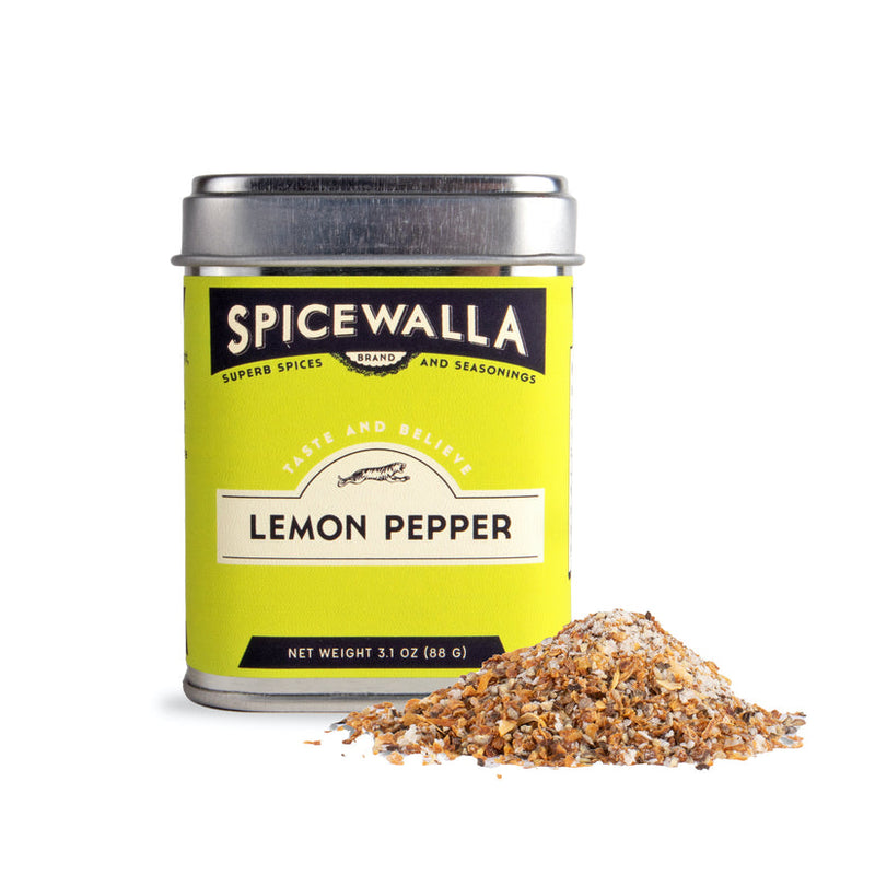 Spicewalla | Lemon Pepper Seasoning tin with a small pile of spice blend, featuring citrusy lemon peel and spicy black peppercorns for enhancing chicken, fish, or vegetables.